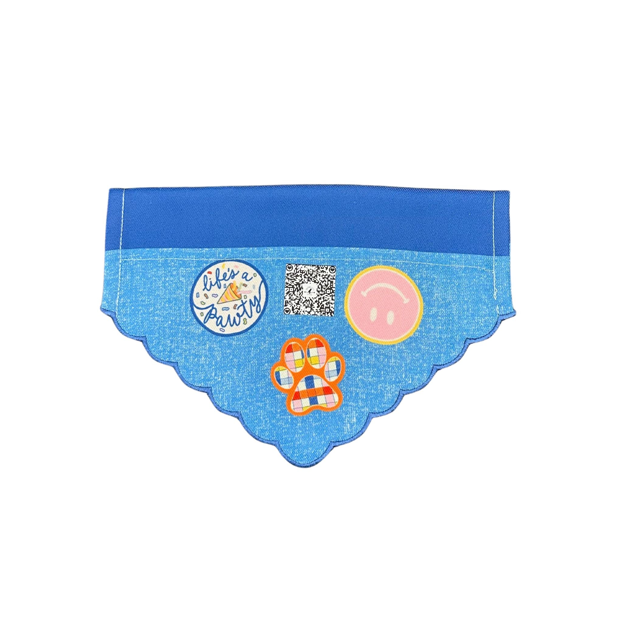 Front view of the "Life's a Pawty" blue dog bandana featuring two shades of blue with four vinyl designs: a paw print, an upside-down smiley face, a multi-shade paw print, and Beloved Lily's QR 
