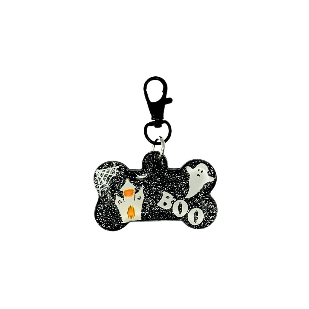 Bone-shaped pet ID tag with a Halloween design featuring ghosts and the word "BOO," made of resin with a customizable QR code and keychain clasp.