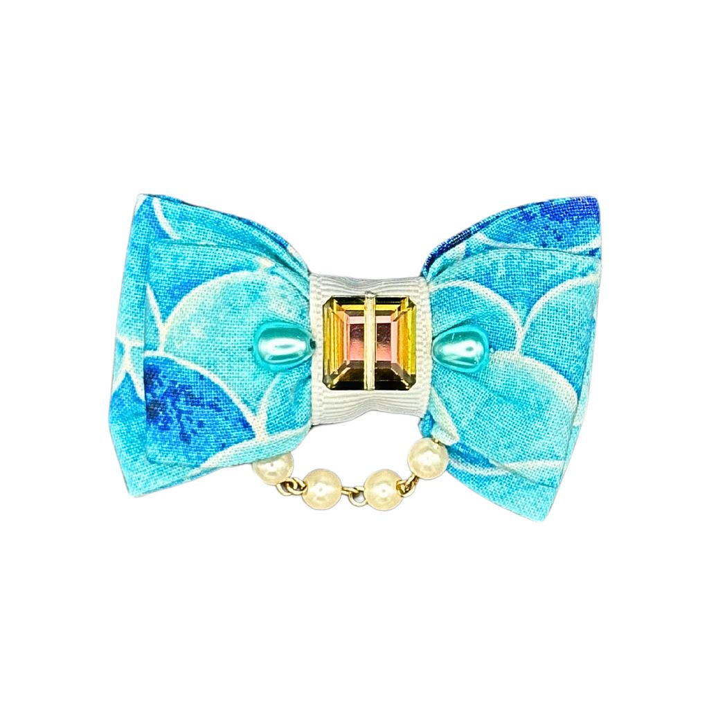 Blue mermaid scale cat collar bow with gemstone center and pearl accents, ocean-inspired pet accessory from Beloved Lily's Pet Company.