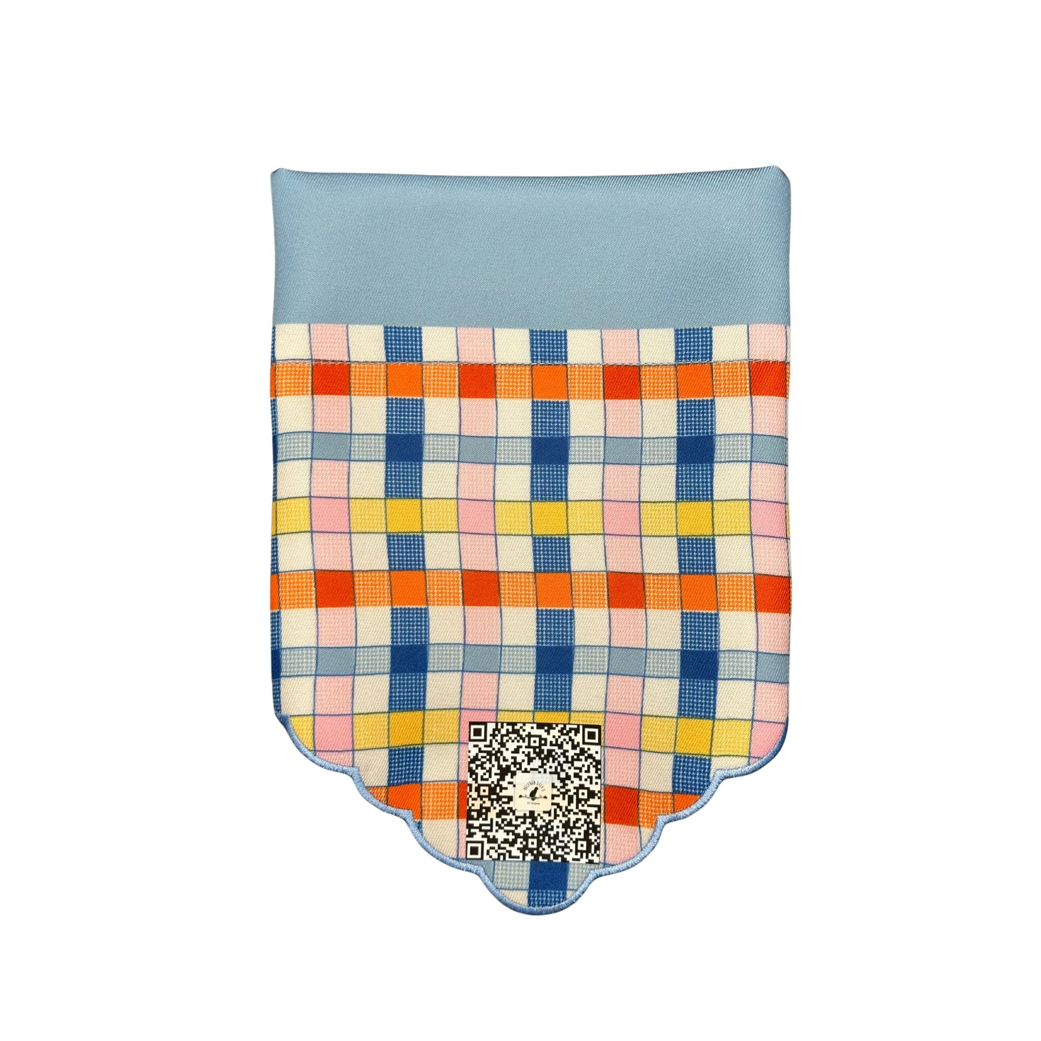 Front folded view of the "Checkered Chic" dog bandana, highlighting the secure slip-over-collar design, the light blue top, and the multi-colored checkered pattern with the QR code placement.