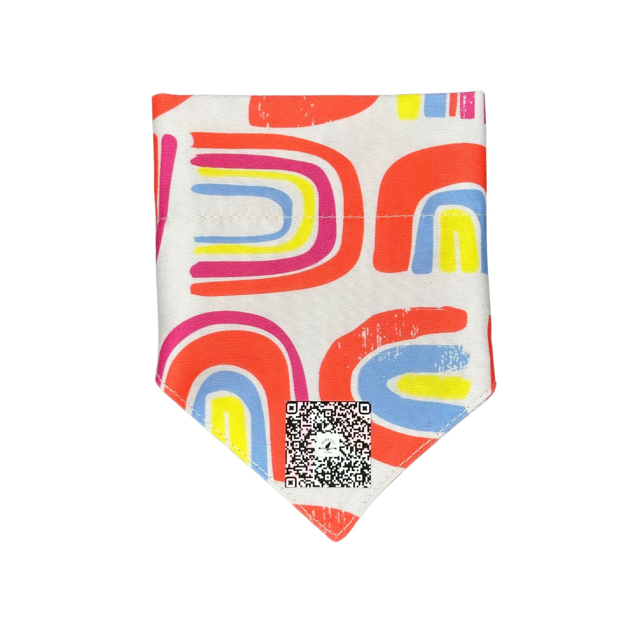Front folded view of the "Pawsitive Vibes" rainbow bow dog bandana, highlighting the secure slip-over-collar design, the stylish bow, and the QR code placement.