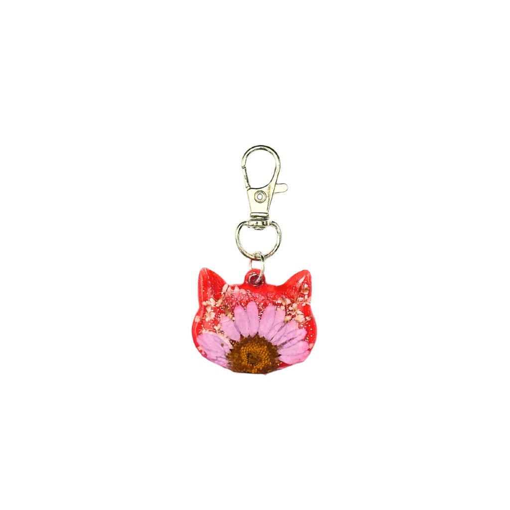 Red resin cat head-shaped pet ID tag with pink flower and customizable QR code, featuring a keychain clasp.