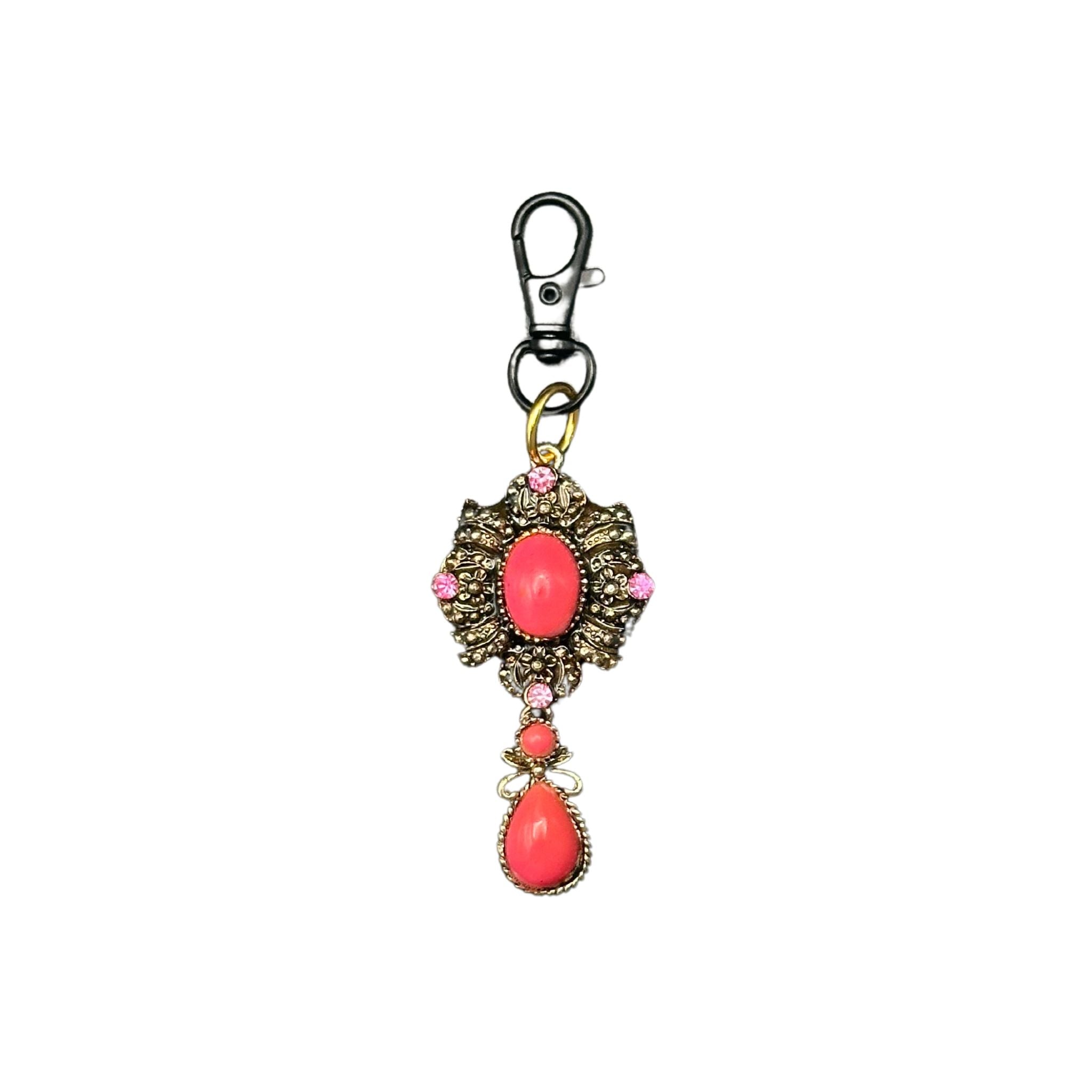 Vintage-inspired bronze pet ID tag adorned with pink gems and coral stones, featuring a QR code on the back for customizable pet information.